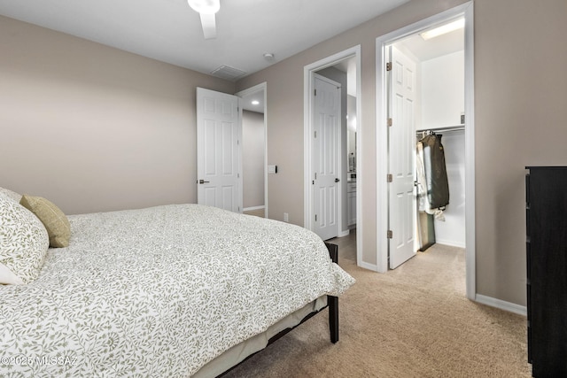 7106 W Foothills Acacia Pl, Marana, AZ 85658 - bedroom with light colored carpet, baseboards, a walk in closet, a closet, and a ceiling fan