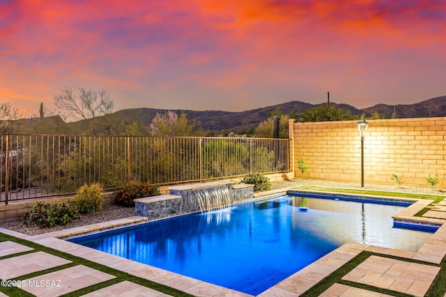 7106 W Foothills Acacia Pl, Marana, AZ 85658 - pool at dusk featuring a fenced backyard and a mountain view