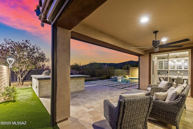 7106 W Foothills Acacia Pl, Marana, AZ 85658 - patio terrace at dusk featuring a patio area, a fenced backyard, and a ceiling fan
