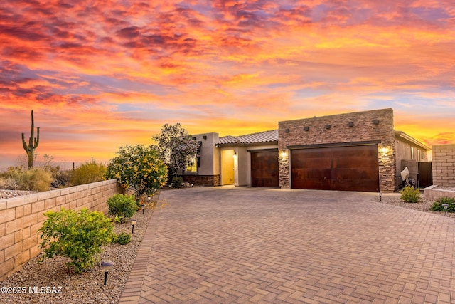 7106 W Foothills Acacia Pl, Marana, AZ 85658 - view of front of home featuring an attached garage, decorative driveway, and stucco siding