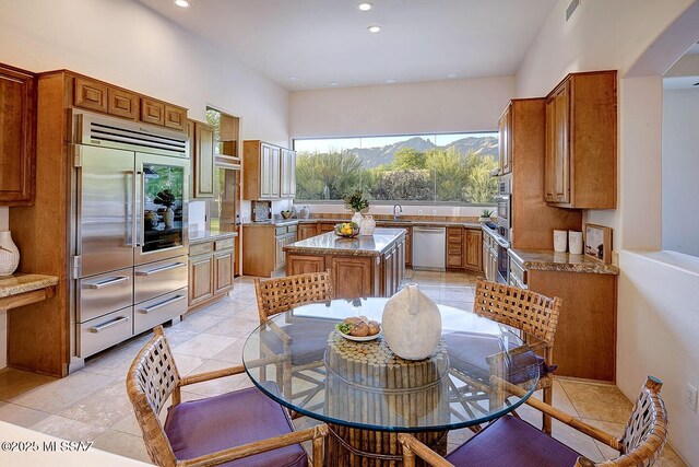5269 N Pontatoc Rd, Tucson, AZ 85718 - kitchen featuring stainless steel appliances, brown cabinets, a sink, recessed lighting, and arched walkways