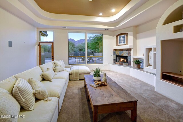 5269 N Pontatoc Rd, Tucson, AZ 85718 - carpeted living room with a tile fireplace, a raised ceiling, and recessed lighting