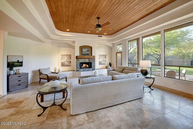 5269 N Pontatoc Rd, Tucson, AZ 85718 - living room featuring wood ceiling, a tray ceiling, a fireplace, a ceiling fan, and recessed lighting