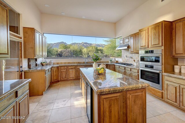 5269 N Pontatoc Rd, Tucson, AZ 85718 - kitchen featuring stainless steel appliances, stone countertops, a sink, brown cabinetry, and tasteful backsplash