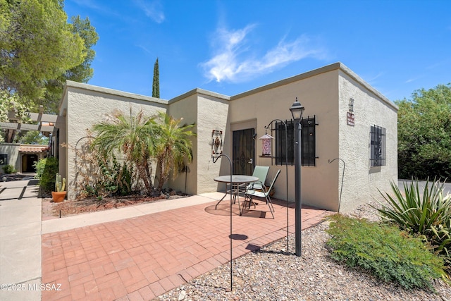 1018 Cll De La Temporada, Green Valley, AZ 85614 - view of front of home with stucco siding and a patio area