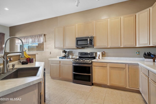 182 N Desert Park Pl, Tucson, AZ 85745 - kitchen with stainless steel appliances, a sink, light brown cabinetry, light countertops, and light tile patterned floors