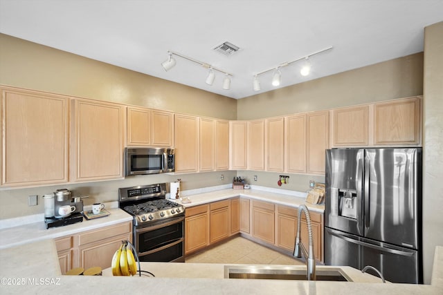 182 N Desert Park Pl, Tucson, AZ 85745 - kitchen with light brown cabinetry, appliances with stainless steel finishes, a sink, light countertops, and light tile patterned floors