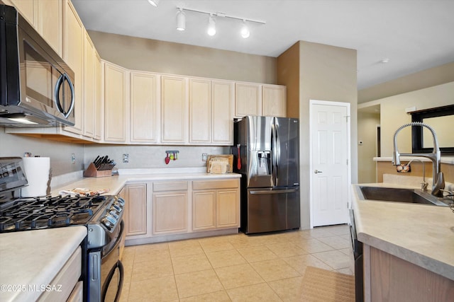 182 N Desert Park Pl, Tucson, AZ 85745 - kitchen with stainless steel appliances, a sink, light brown cabinets, and light tile patterned flooring