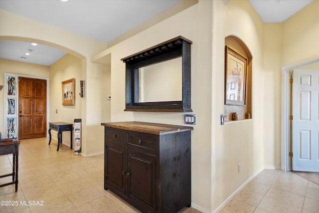 182 N Desert Park Pl, Tucson, AZ 85745 - corridor featuring light tile patterned floors, baseboards, arched walkways, and recessed lighting