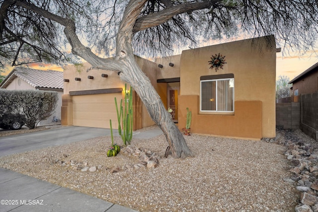182 N Desert Park Pl, Tucson, AZ 85745 - pueblo revival-style home featuring asphalt driveway, stucco siding, and a garage