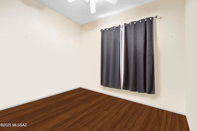 182 N Desert Park Pl, Tucson, AZ 85745 - spare room with a ceiling fan, dark wood-type flooring, and baseboards