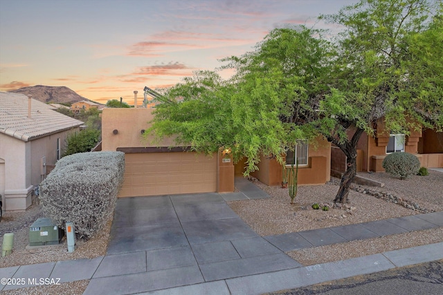 182 N Desert Park Pl, Tucson, AZ 85745 - pueblo revival-style home featuring stucco siding, concrete driveway, and an attached garage