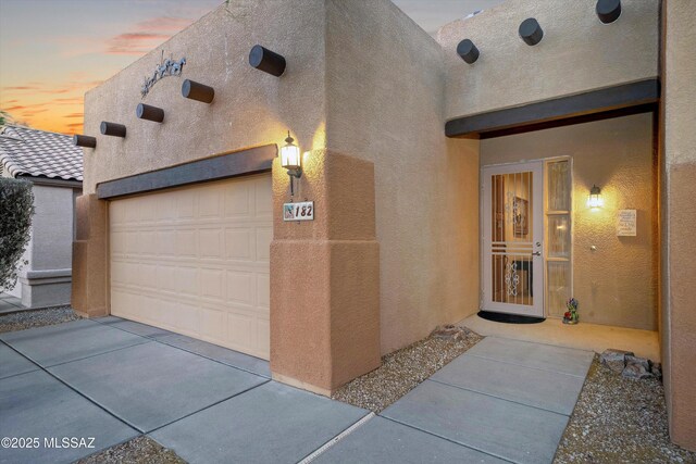 182 N Desert Park Pl, Tucson, AZ 85745 - view of front of property with stucco siding and a garage