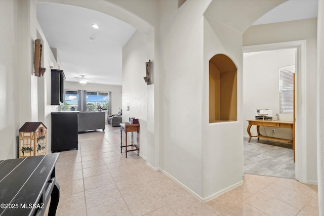 182 N Desert Park Pl, Tucson, AZ 85745 - corridor with light tile patterned floors, arched walkways, and baseboards