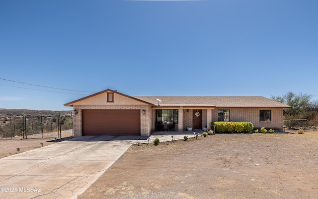 253 Grillo Ct, Rio Rico, AZ 85648 - ranch-style house with an attached garage, concrete driveway, brick siding, and covered porch