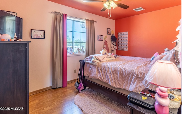 253 Grillo Ct, Rio Rico, AZ 85648 - bedroom featuring wood finished floors, baseboards, and ceiling fan
