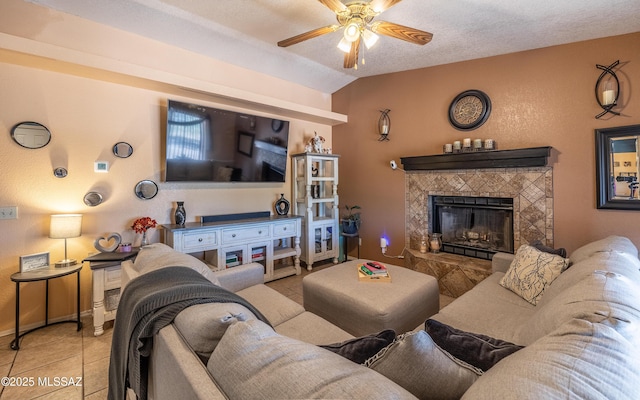 253 Grillo Ct, Rio Rico, AZ 85648 - living room with tile patterned floors, ceiling fan, lofted ceiling, a fireplace, and baseboards