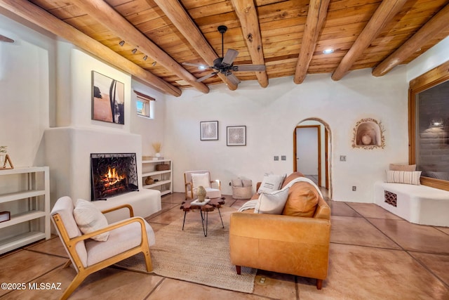 3008 E Placita Santa Lucia, Tucson, AZ 85716 - living room featuring a wood ceiling with exposed beams, a lit fireplace, arched walkways, a ceiling fan, and recessed lighting