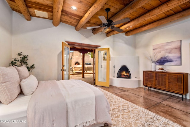 3008 E Placita Santa Lucia, Tucson, AZ 85716 - bedroom with finished concrete floors, a wood ceiling with exposed beams, access to outside, and a warm lit fireplace