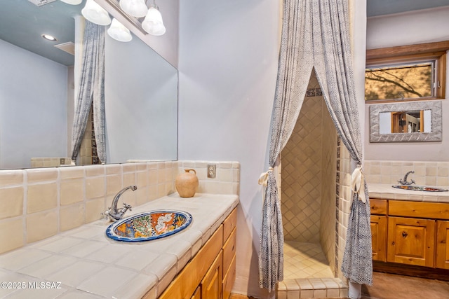 3008 E Placita Santa Lucia, Tucson, AZ 85716 - bathroom with decorative backsplash, vanity, a tile shower, and recessed lighting