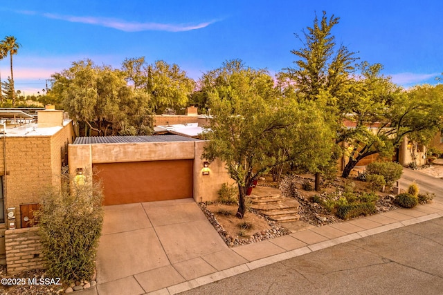 3008 E Placita Santa Lucia, Tucson, AZ 85716 - view of front of home featuring driveway, a garage, a metal roof, and stucco siding