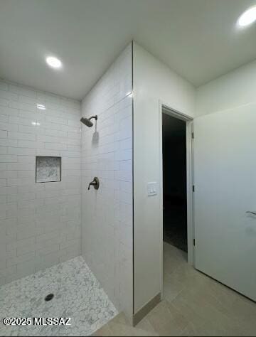bathroom featuring a tile shower, recessed lighting, and tile patterned floors