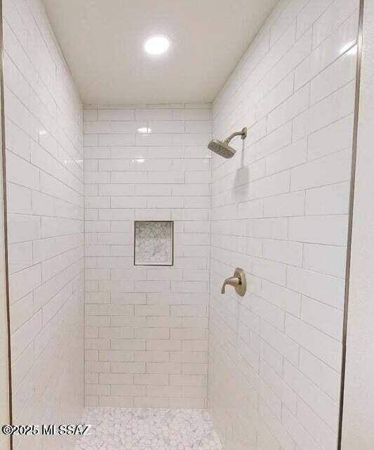 bathroom with a tile shower