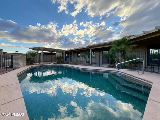 view of swimming pool featuring fence