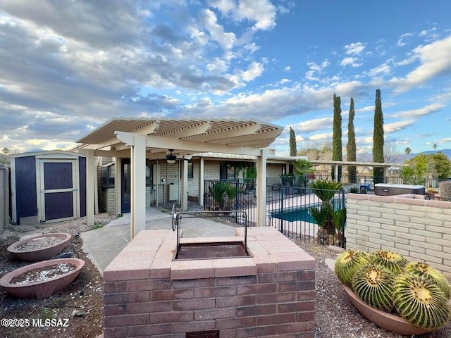 view of patio / terrace with a pergola, fence, a storage shed, an outdoor structure, and an outdoor kitchen