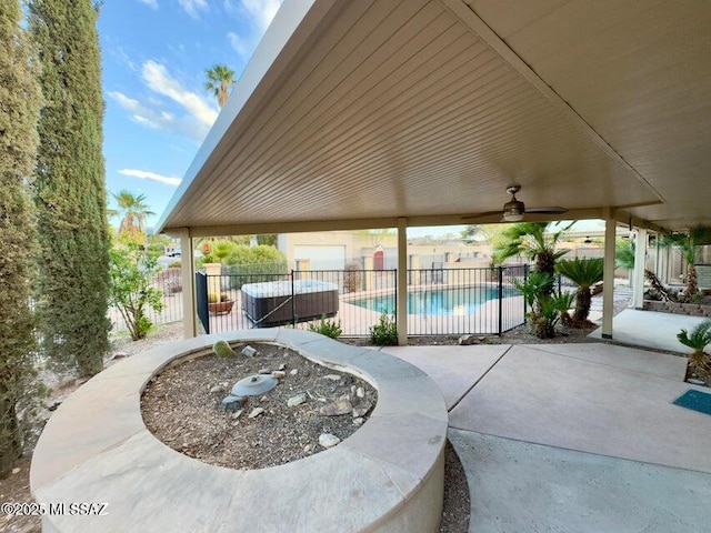 view of patio / terrace featuring a fenced backyard, ceiling fan, and a jacuzzi