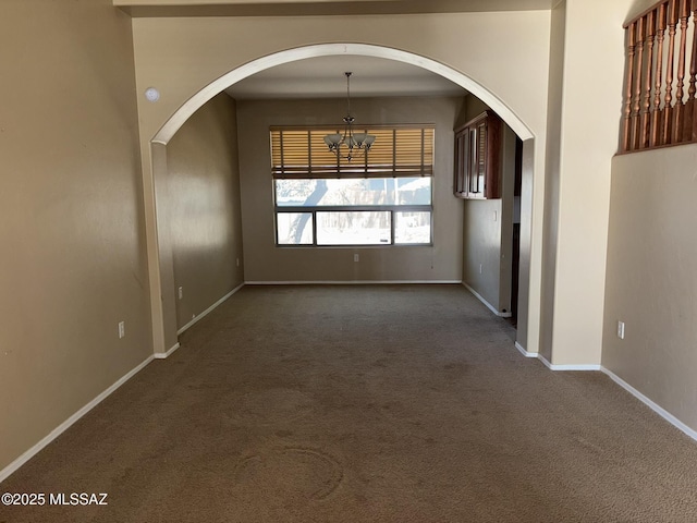 262 W Calle Paso Suave, Sahuarita, AZ 85629 - unfurnished dining area featuring a chandelier, dark carpet, arched walkways, and baseboards