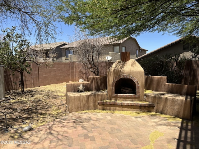 262 W Calle Paso Suave, Sahuarita, AZ 85629 - fenced backyard featuring an outdoor brick fireplace and a patio