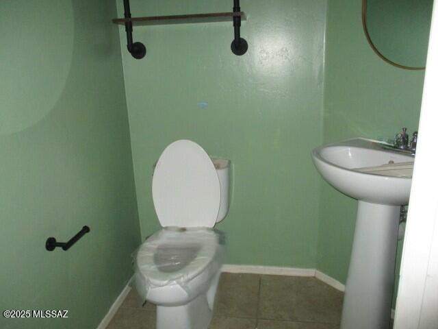 262 W Calle Paso Suave, Sahuarita, AZ 85629 - half bath featuring tile patterned flooring, toilet, baseboards, and a sink