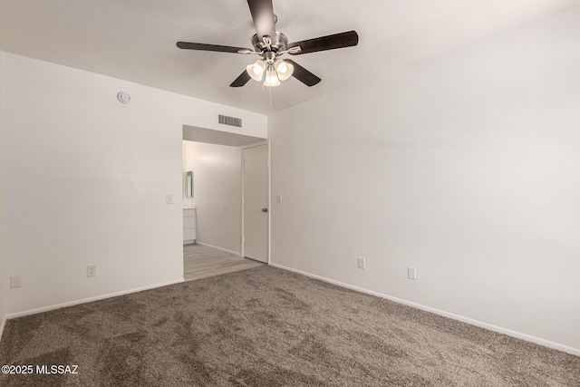 unfurnished room with carpet flooring, a ceiling fan, and baseboards