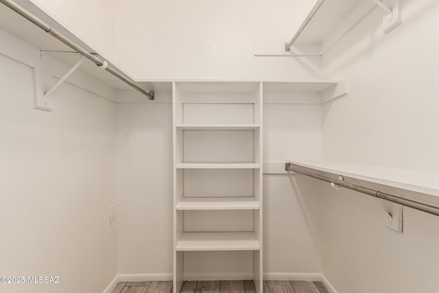 spacious closet with light wood-style floors