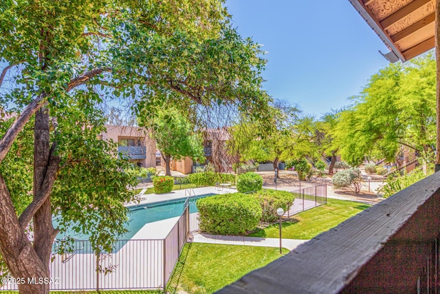 view of property's community with a yard and a swimming pool