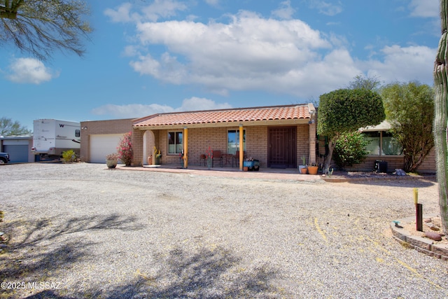 2282 W Rapallo Way, Tucson, AZ 85741 - view of front of home with a garage, driveway, brick siding, covered porch, and a tiled roof
