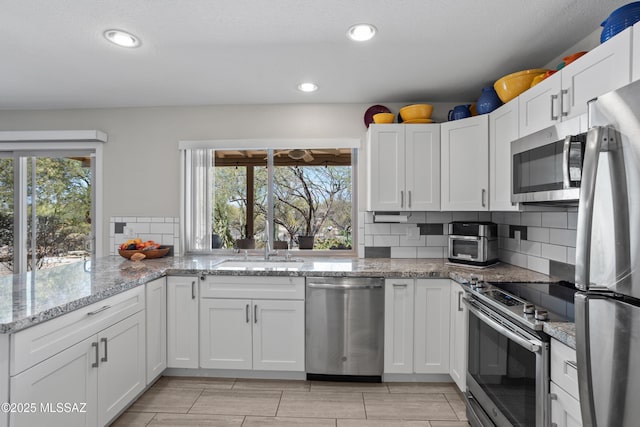 2282 W Rapallo Way, Tucson, AZ 85741 - kitchen featuring appliances with stainless steel finishes, a sink, healthy amount of natural light, decorative backsplash, and recessed lighting