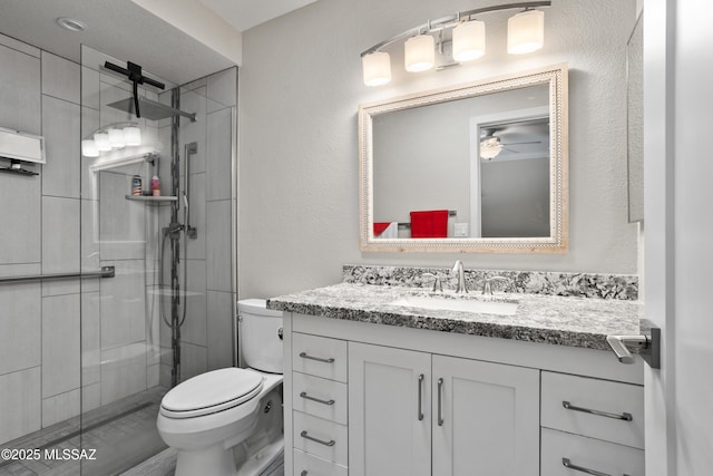 2282 W Rapallo Way, Tucson, AZ 85741 - full bathroom featuring a stall shower, toilet, vanity, and a ceiling fan