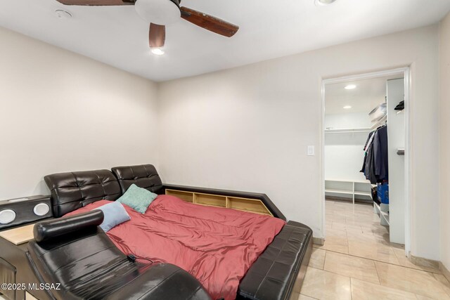 bedroom featuring recessed lighting, a walk in closet, ceiling fan, baseboards, and light tile patterned floors