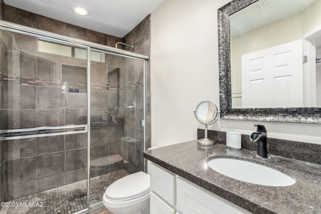 bathroom featuring toilet, a shower stall, vanity, and recessed lighting
