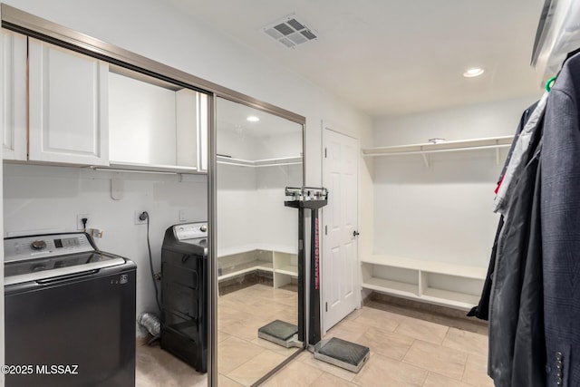 washroom with separate washer and dryer, cabinet space, and recessed lighting