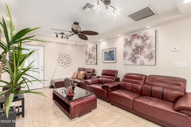 cinema room featuring a tray ceiling, a ceiling fan, light tile patterned floors, and recessed lighting