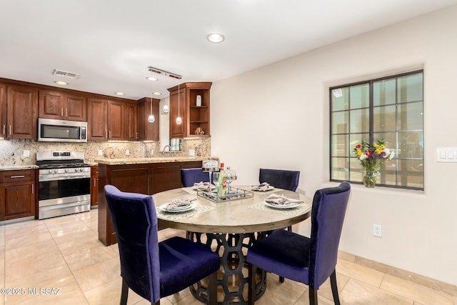 dining room with light tile patterned floors and recessed lighting