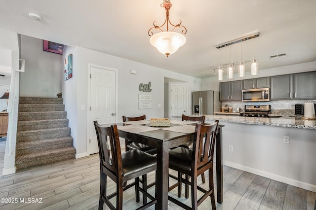 14570 S Sumac Dr, Sahuarita, AZ 85629 - dining area with stairway, light wood-style flooring, and baseboards