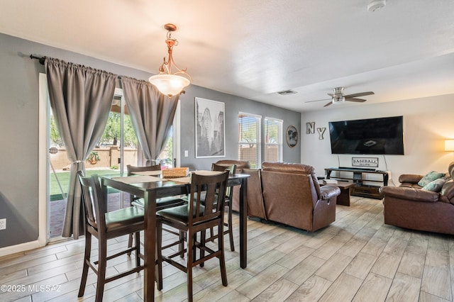 14570 S Sumac Dr, Sahuarita, AZ 85629 - dining space featuring wood tiled floors, a ceiling fan, and baseboards