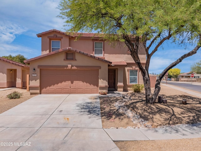 14570 S Sumac Dr, Sahuarita, AZ 85629 - view of front of property featuring driveway, stucco siding, a tiled roof, and an attached garage