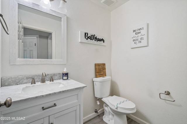 14570 S Sumac Dr, Sahuarita, AZ 85629 - bathroom with toilet, wood finished floors, baseboards, and vanity