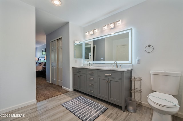 14570 S Sumac Dr, Sahuarita, AZ 85629 - full bath featuring wood finished floors, double vanity, toilet, ensuite bath, and baseboards