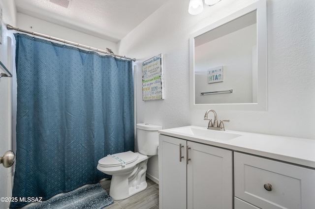 14570 S Sumac Dr, Sahuarita, AZ 85629 - full bathroom featuring toilet, vanity, wood finished floors, and a shower with shower curtain
